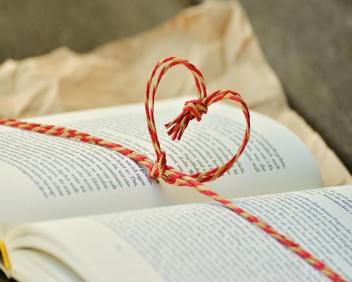 woman relaxing on a sofa reading a book with soft lighting